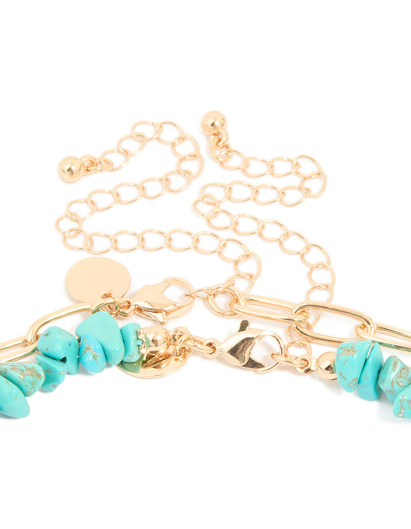 Designed with attention to detail, this layered necklace highlights the clasp, beaded turquoise material, floral touches, ocean-inspired and charms in gold clasp detail view