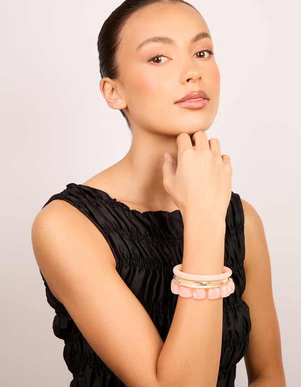 Explore pink acrylic and gold smooth bangles 3-pack with beaded bracelet styling on model view