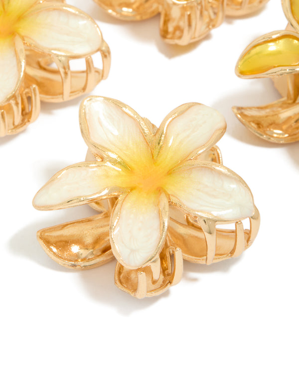 Featuring small yellow enamel frangipani flower claw clips in a 4-pack with floral print and gold detailing detail view