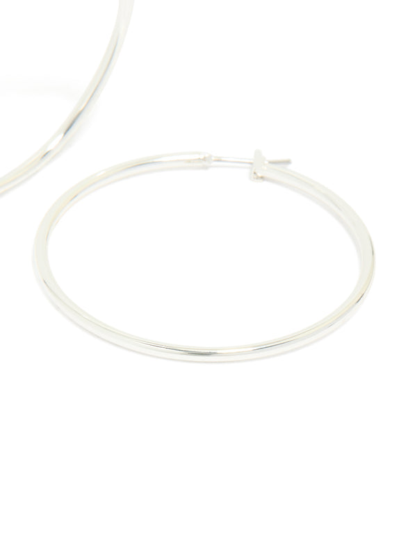 Featuring large thin hoop earrings crafted from silver plated material with closure post detail view