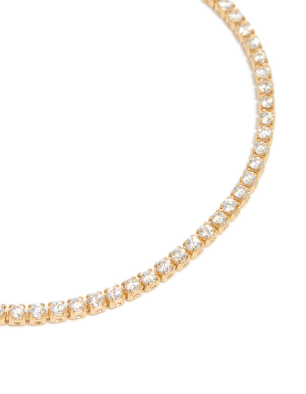 Capturing a dainty gold plated cubic zirconia mini tennis toggle bracelet close up view