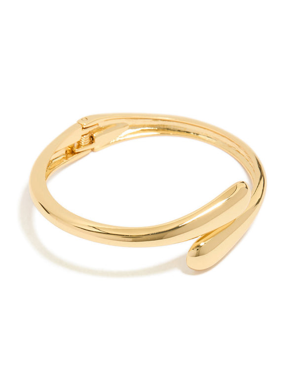 Crafted from gold plated material, this open wrap hinged bangle features a sleek design front view