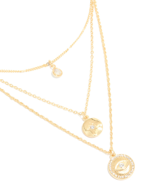 Showcasing is this gold plated layered necklace with cubic zirconia, evil eye and circle pendants close up view