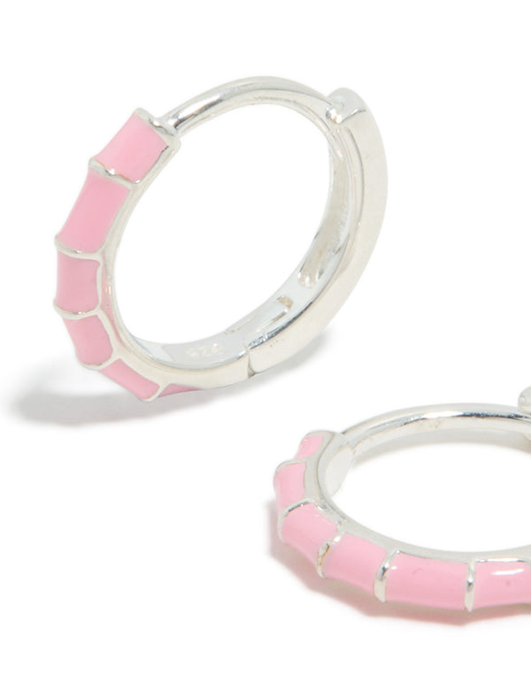 Detailed view of sterling silver pink enamel bamboo huggie earrings with hoop closure close up view
