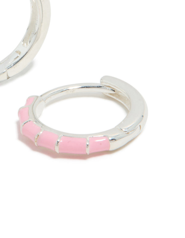 Highlighting sterling silver pink enamel bamboo huggie earrings with hoop closure post detail view