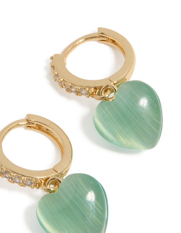 Highlighting gold plated cubic zirconia pave and green heart charm huggie earrings in post detail view