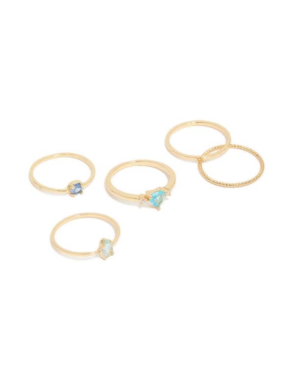 Featuring gold plated blue cubic zirconia and bubble rings in a stackable 5-pack with oval, round, and heart stone details, front view