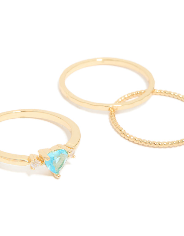 Crafted from gold plated metal, these blue cubic zirconia and bubble rings in a stackable 5-pack feature round, oval and heart accents side detail view