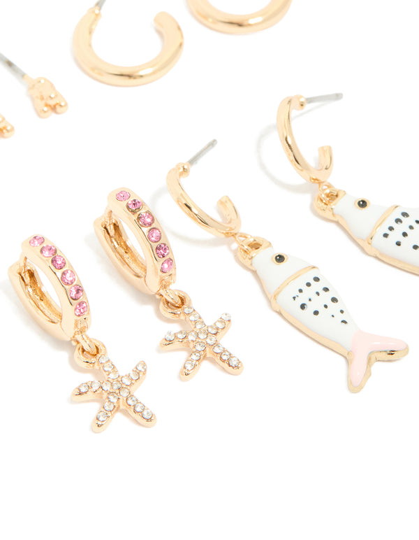 Crafted from gold pink and enamel, this fish earring 5-pack features animal ocean accents in white black, huggie stud hoop closures, close up view