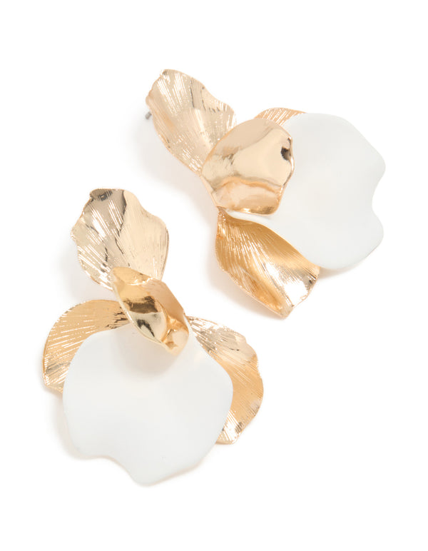 Showcasing statement stud earrings featuring floral design in gold and white front view