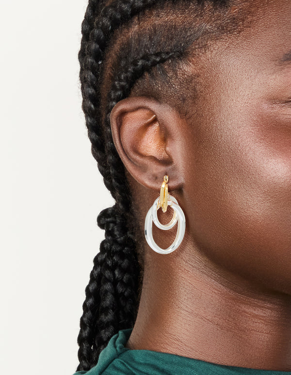 Mixed metal plated double link illusion hoop earrings with statement style in gold and silver on ear view
