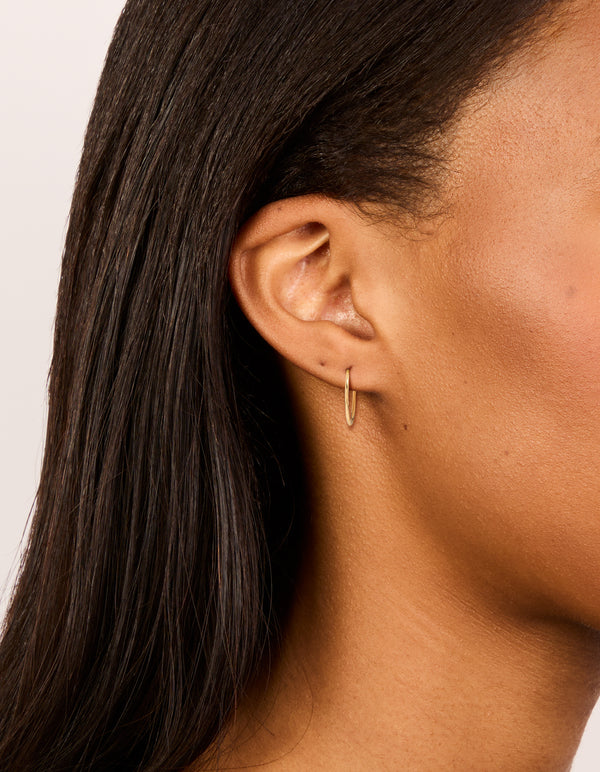 Showcasing gold plated surgical steel 12 MM fine sleeper hoop earrings in front view