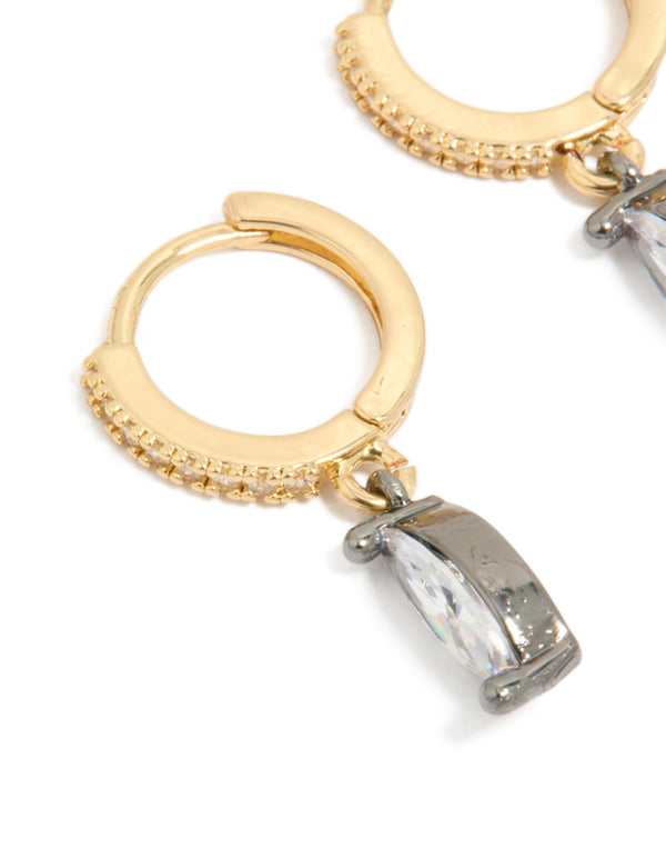 Showcasing mixed metal plated cubic zirconia oval huggie drop earrings in gold, silver, and clear tones close up view
