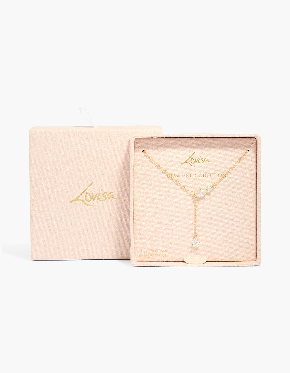 Crafted from gold plated material, this cubic zirconia trio Y-necklace is presented in packaging close up view