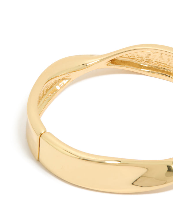 Designed with twisted thick styling, this gold plated statement chunky bangle close up view