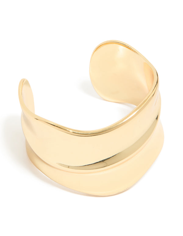 Showcasing a gold plated wide organic wrist cuff with statement bangle design front view