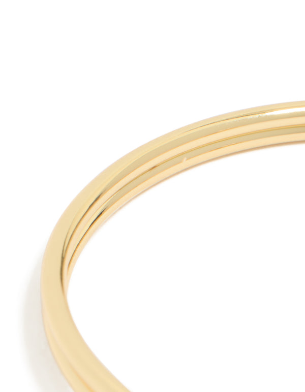 Highlighting the gold plated double knotted centre wrist cuff with statement styling closure detail view