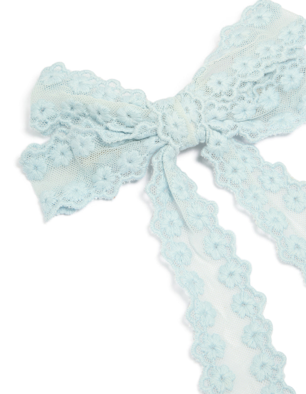 Showcasing floral fabric bow hair clip in light blue with textured knot center, detail view