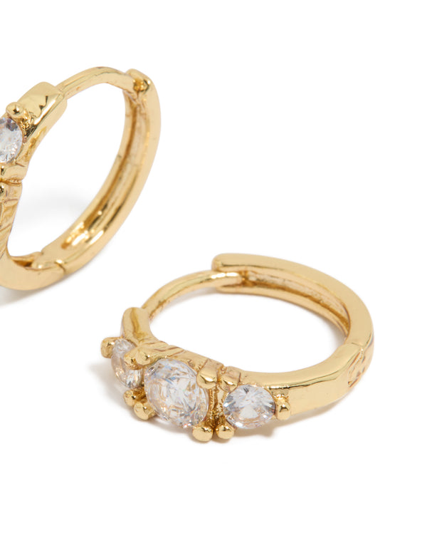 Displaying gold plated mixed sized cubic zirconia mini huggie earrings with huggie post detail view