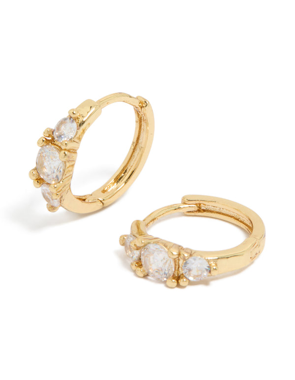 Showcasing gold plated mixed sized cubic zirconia mini huggie earrings with huggie closure front view