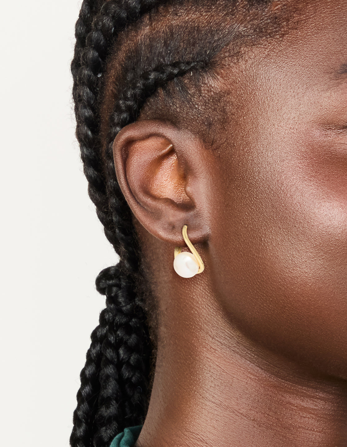 Featuring gold plated freshwater pearl twist hoop earrings on ear view