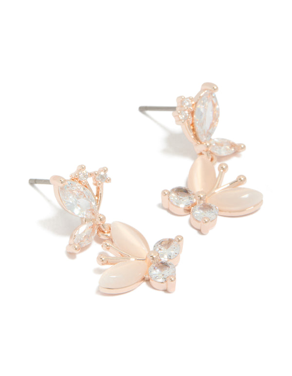 Showcasing drop earrings with double butterfly charm featuring cubic zirconia in rose gold plated finish front view