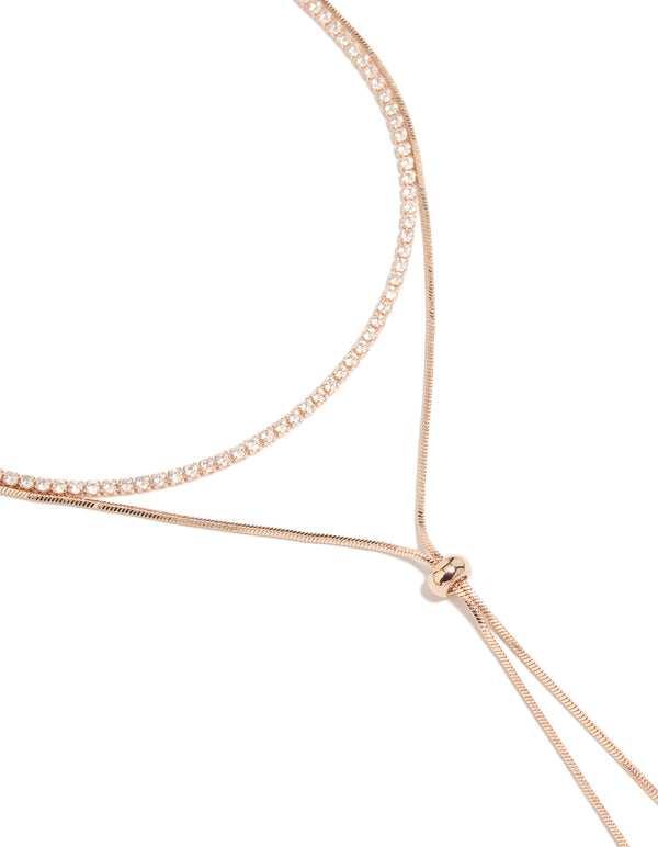 Showcasing a rose gold plated cubic zirconia cup chain and snake layered Y-necklace with crystal accents close up view