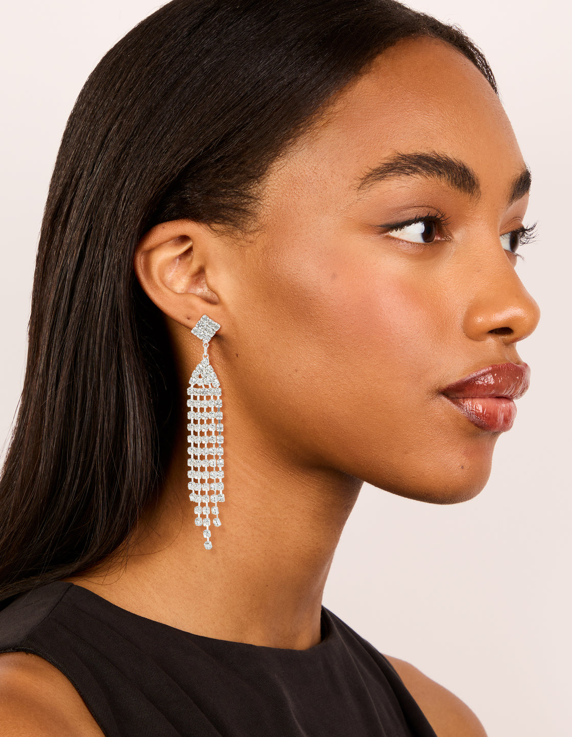 Presenting silver diamante sparkling stud drop earrings featuring tassel in clear on model view
