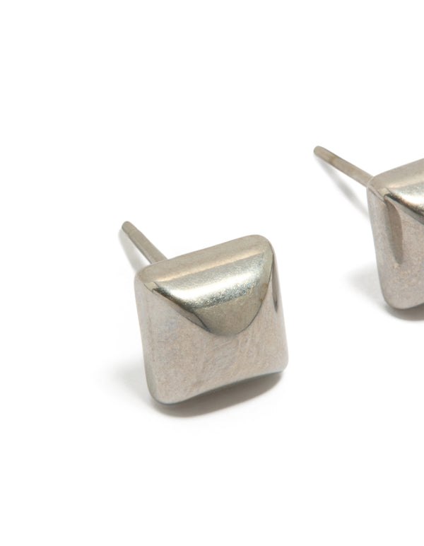 Highlighting mens waterproof stainless steel studded earrings in silver with closure close up view