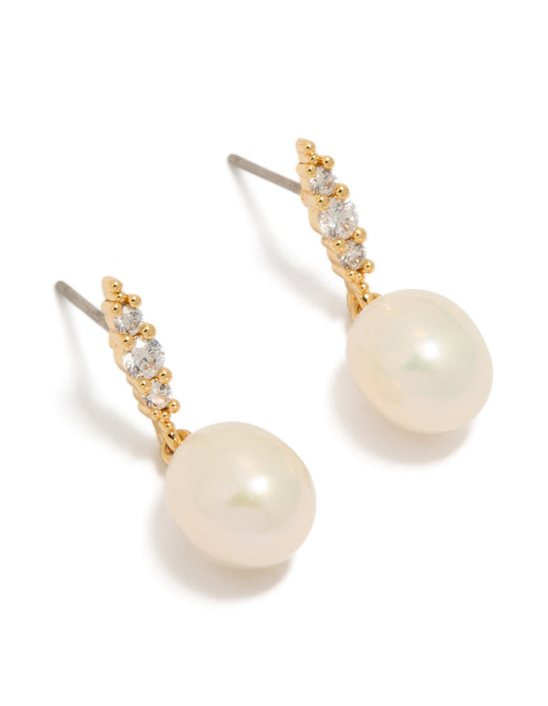 Showcasing statement gold plated cubic zirconia and freshwater pearl drop earrings front view