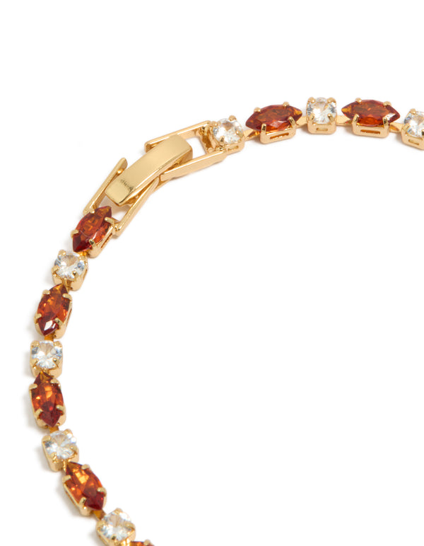 Presenting a gold plated clear and cognac cubic zirconia multi cut tennis bracelet closure detail view