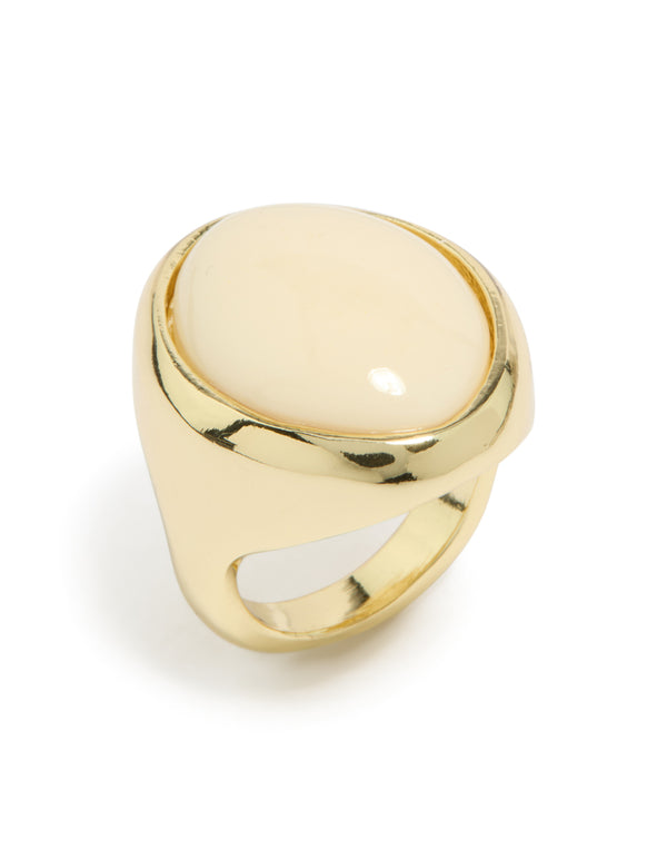 Crafted from gold plated material featuring oval cream stone statement ring in ivory front view