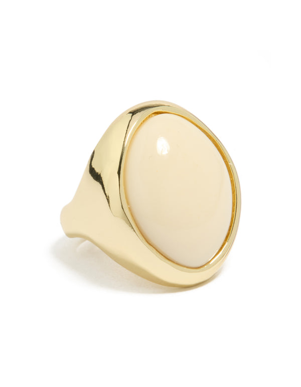 Showcasing a gold plated statement ring with oval cream stone side detail view