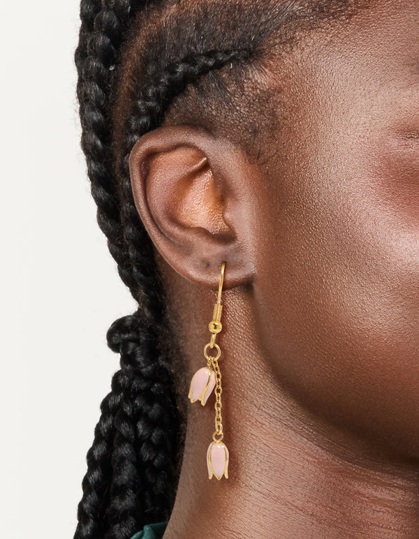 Waterproof gold plated stainless steel pink tulips drop earrings featuring floral pattern on ear view
