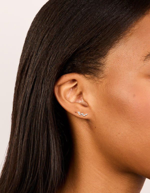 Showcasing silver crawler studs featuring marquise cut cubic zirconia stones in waterproof stainless steel and flat back closure on ear view
