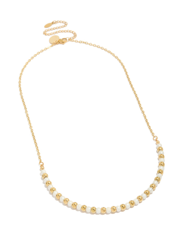 Elegant alternating balls with pearl accents crafted from waterproof stainless steel in gold plated finish front view