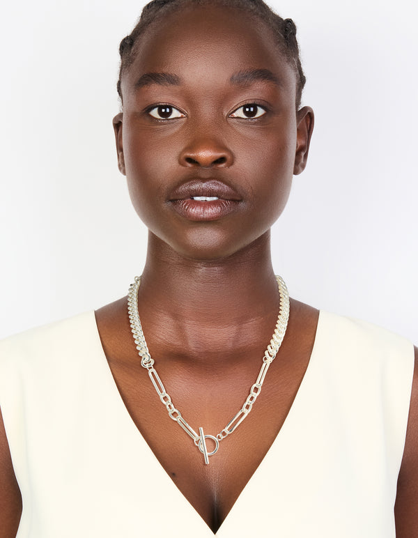 Featuring a waterproof stainless steel long curb chain toggle necklace designed with silver plated material in statement style on model view