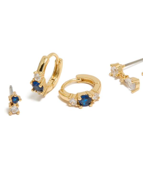 Featuring gold plated mixed cut blue cubic zirconia mini earrings in a 3-pack with crystal huggie closure close up view