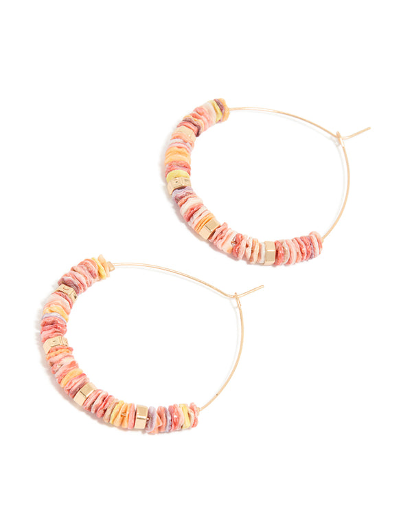 Showcasing large hoop earrings with beaded genuine pink shells and statement style in gold front view