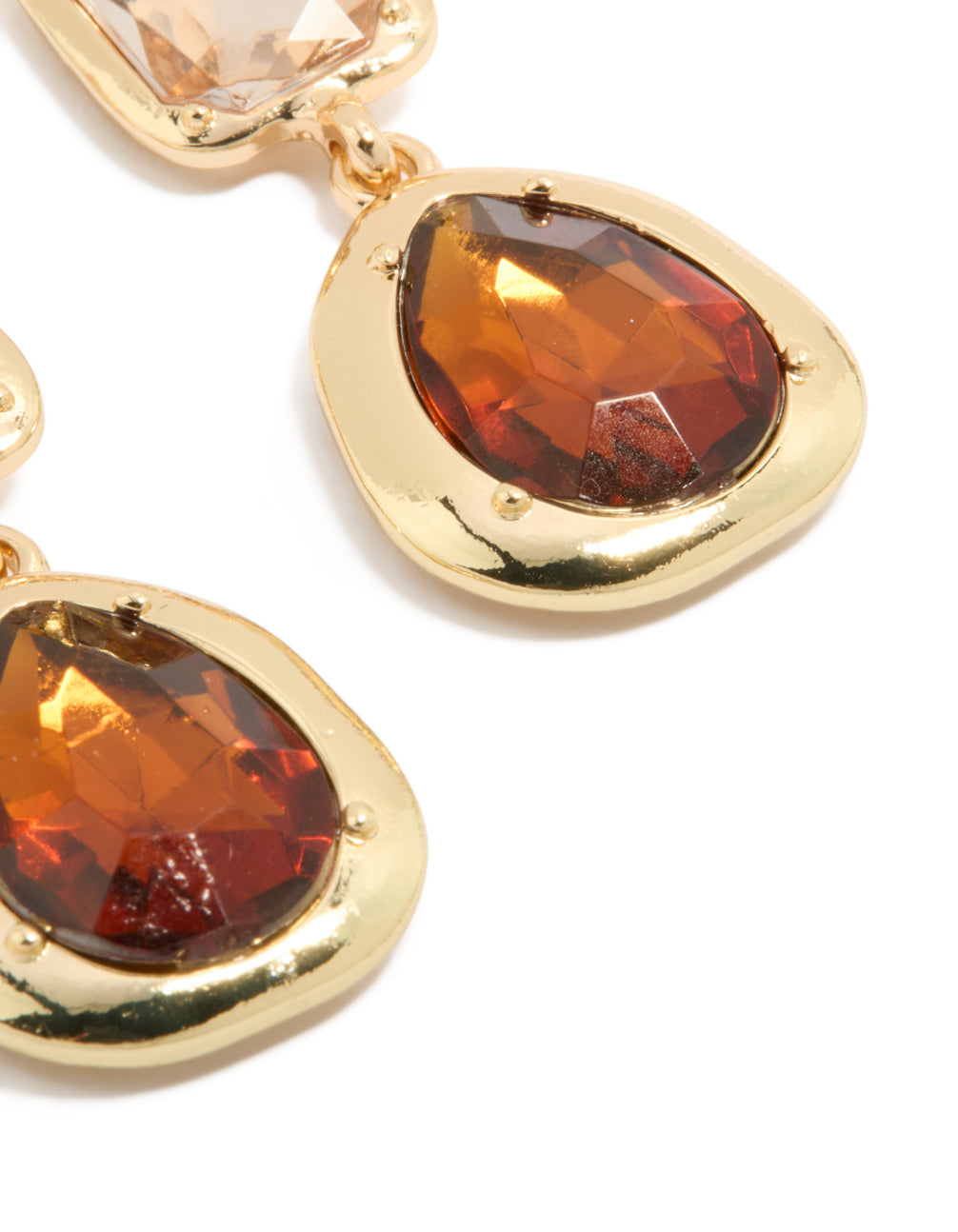 Showcasing statement gold brown diamantes drop earrings close up view