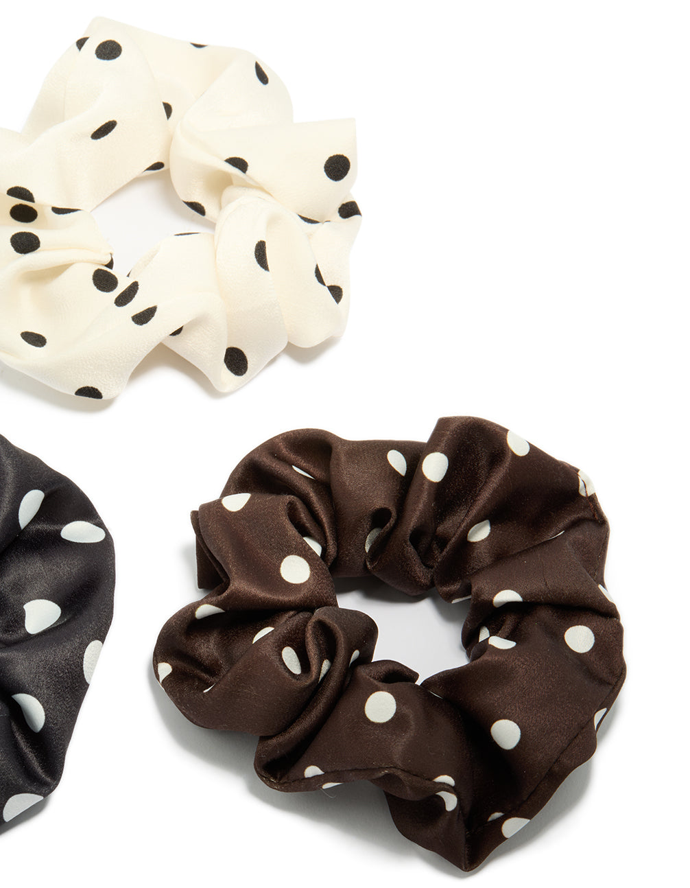 Crafted with polka dot pattern in a 3-pack featuring black, ivory, saddle brown, and white scrunchies side view