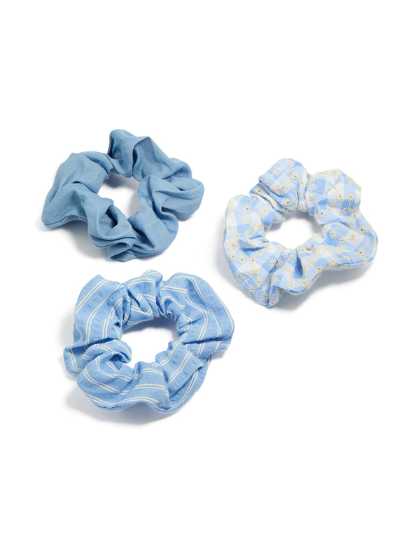 Showcasing a set of floral checkered fabric scrunchies in a 3-pack featuring light sky blue white and light blue accessories front view