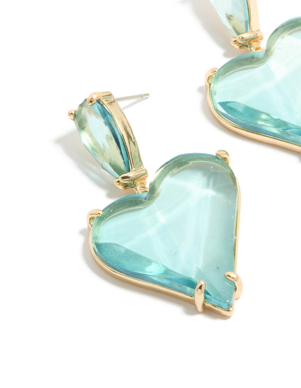 Designed with statement style, these drop earrings with heart design in blue glass stone and gold finish close up view