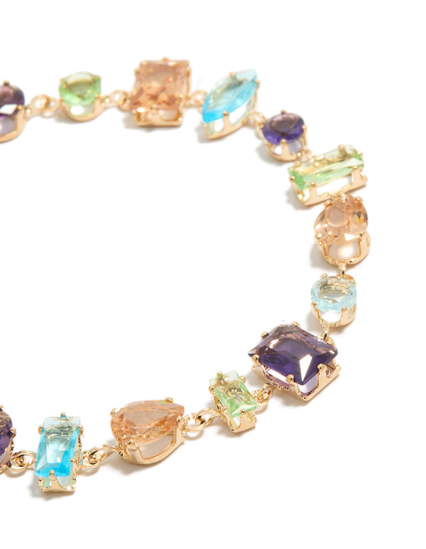 Highlighting a gold irregular shaped multicoloured diamantes stackable bracelet close up view