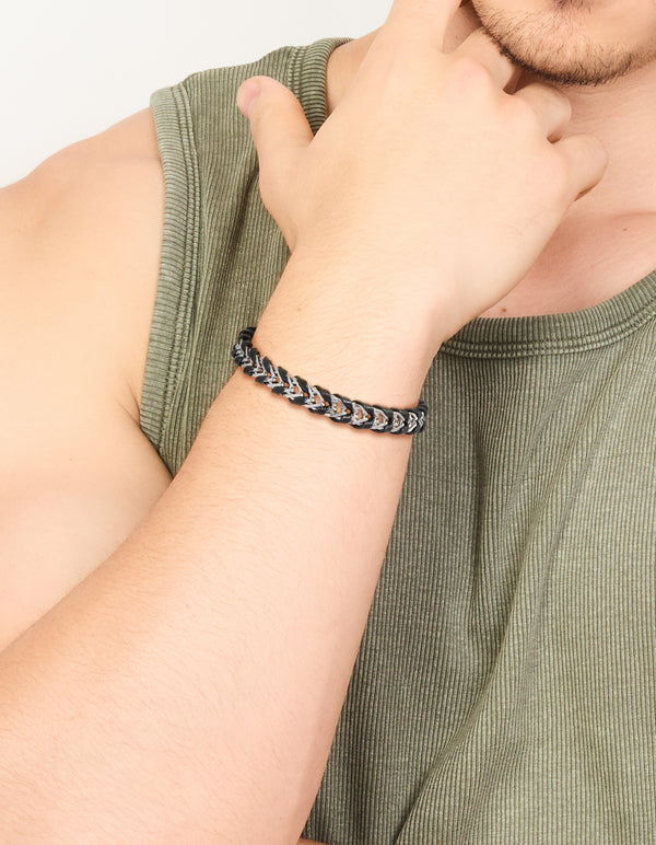 Featuring a mens waterproof stainless steel and black PU leather braided chain bracelet in silver on wrist view