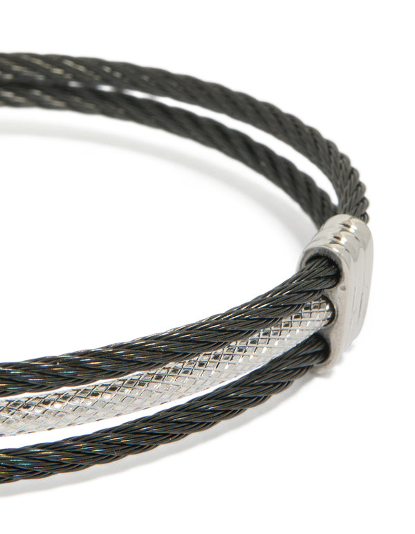 Highlighting a mens waterproof stainless steel black and silver wire twisted wrist cuff bracelet close up view