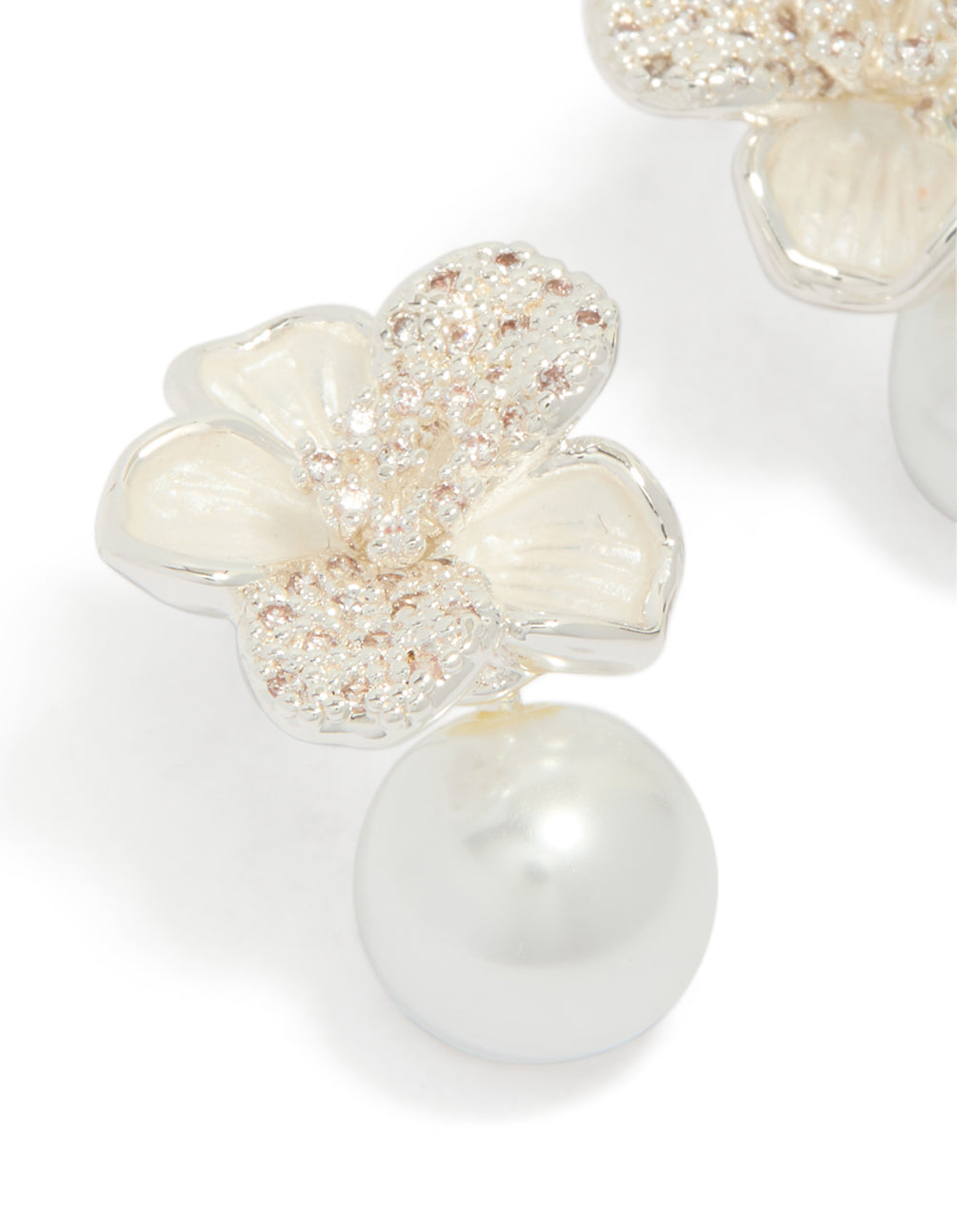 Detailed view of silver plated cubic zirconia flower and pearl drop earrings with floral in clear and ivory close up view