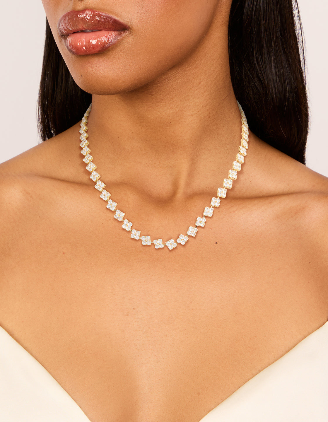 Featuring a floral tennis necklace crafted from gold plated cubic zirconia with crystal details in dainty styling on neck view