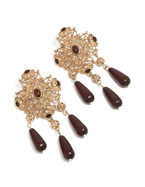 Showcasing antique gold art deco drop earrings with beads design, featuring maroon accents and statement styling front view
