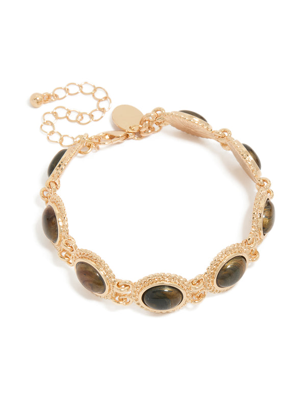 Showcasing a gold bracelet featuring oval stone in brown with textured chain links front view